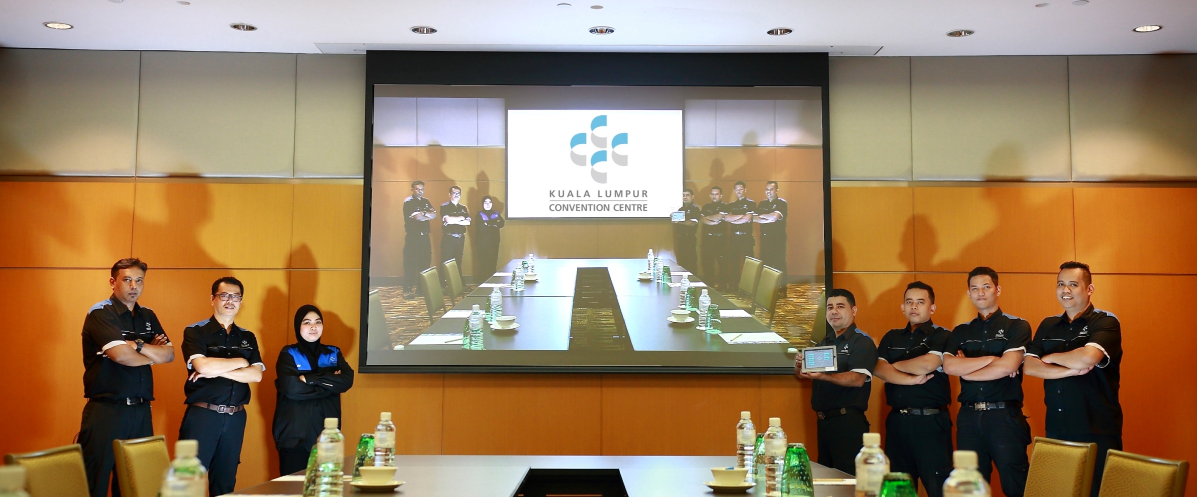 members-of-the-kuala-lumpur-convention-centres-in-house-audio-visual-av-team-proudly-showcasing-the-recently-installed-6500-ansi-lumens-laser-technology-projector